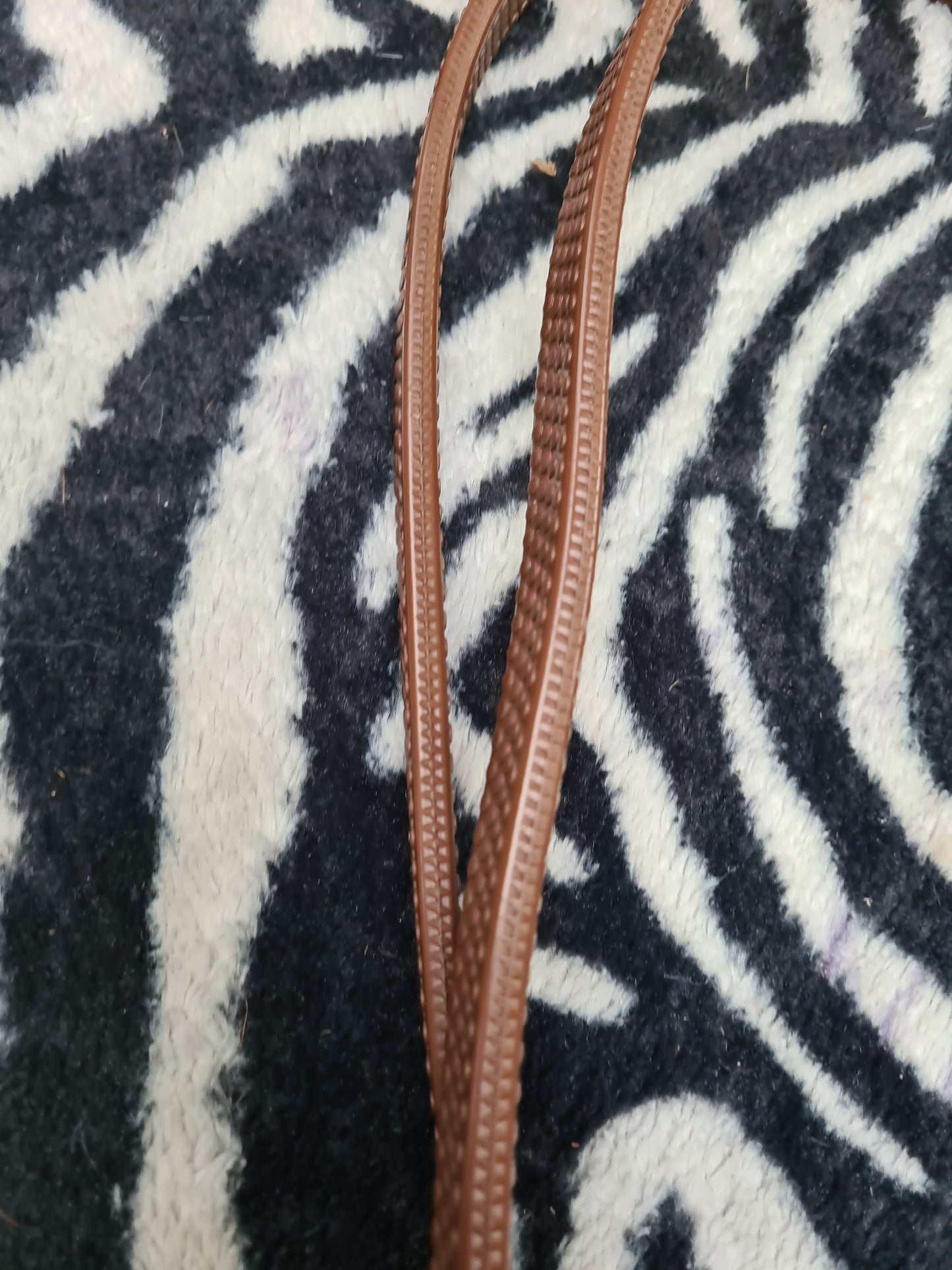 Used pony size brown rubber reins